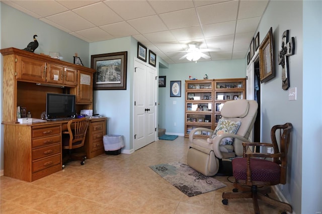 home office with ceiling fan and a paneled ceiling