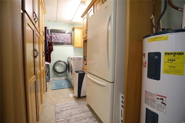 clothes washing area with light colored carpet, water heater, washing machine and clothes dryer, and cabinets