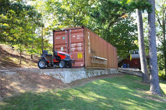 view of outbuilding with a yard