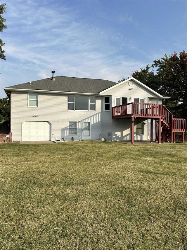 back of property with a wooden deck, a lawn, and a garage