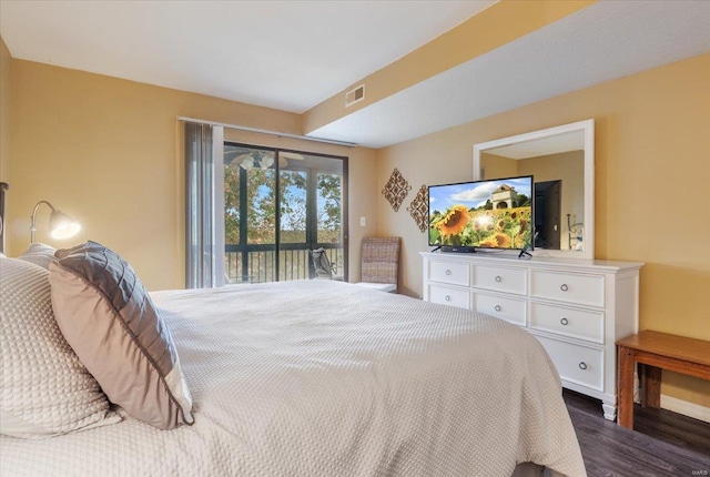 bedroom with access to exterior and dark wood-type flooring