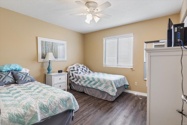 bedroom with ceiling fan, dark hardwood / wood-style floors, and a textured ceiling