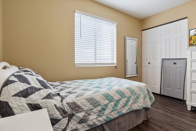 bedroom with multiple windows and dark hardwood / wood-style floors