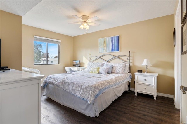 bedroom featuring ceiling fan, dark hardwood / wood-style floors, and a textured ceiling