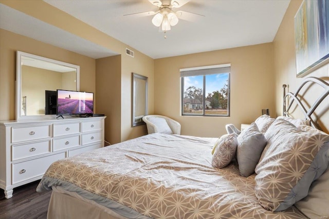 bedroom with dark wood-type flooring and ceiling fan