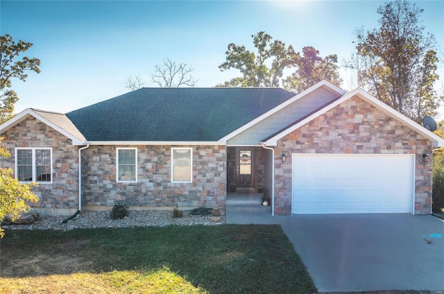 ranch-style house featuring a front lawn and a garage