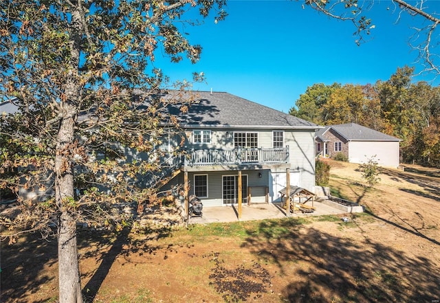 rear view of property with a patio area, a yard, and a deck