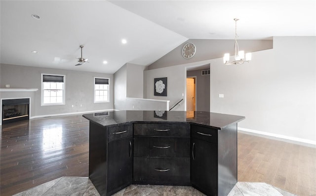 kitchen with pendant lighting, dark hardwood / wood-style flooring, and a kitchen island