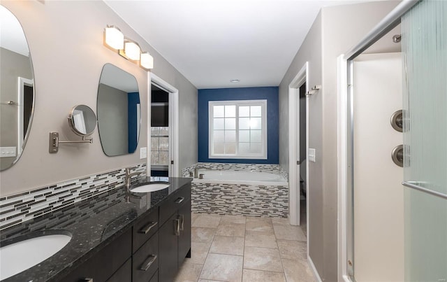 bathroom with shower with separate bathtub, tile patterned floors, vanity, and tasteful backsplash