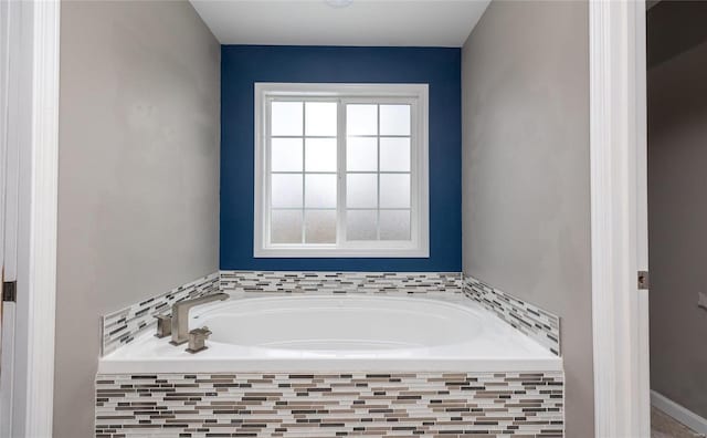 bathroom featuring tiled bath