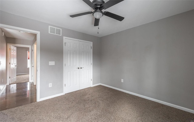 unfurnished bedroom featuring carpet, a closet, and ceiling fan