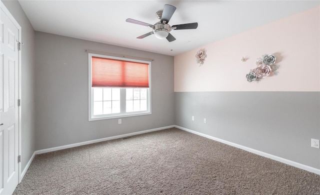 spare room with carpet and ceiling fan