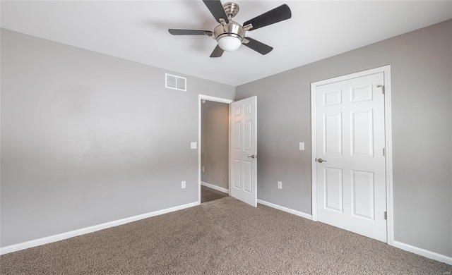 unfurnished bedroom featuring ceiling fan and carpet floors