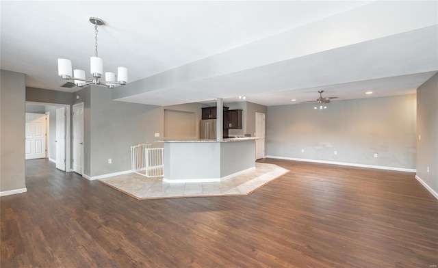 kitchen with high end refrigerator, dark brown cabinets, dark hardwood / wood-style floors, and pendant lighting