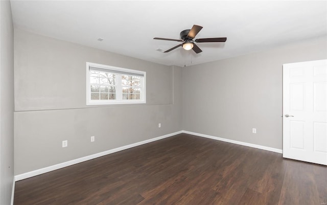 empty room featuring ceiling fan and dark hardwood / wood-style flooring