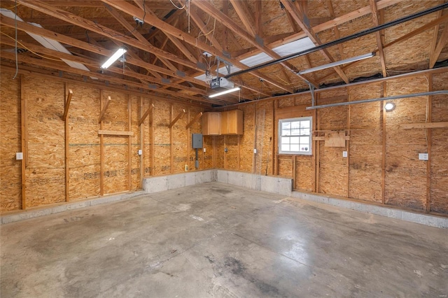 garage with electric panel and a garage door opener