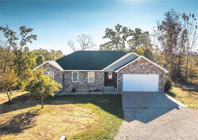 single story home with a garage and a front lawn