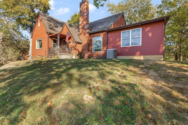 back of property featuring central AC, a yard, and a porch