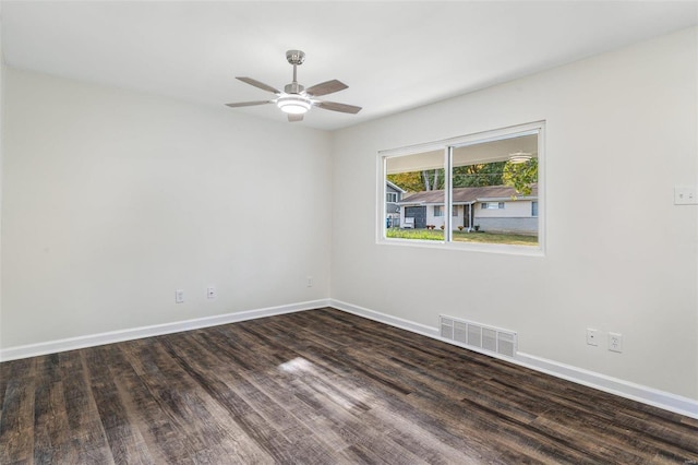 empty room with ceiling fan and dark hardwood / wood-style floors