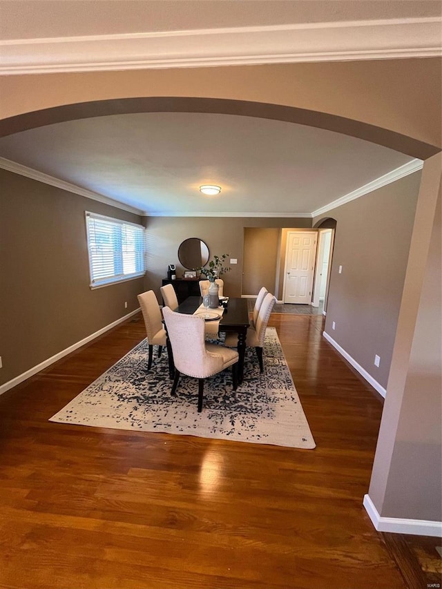 dining area with dark wood-type flooring and ornamental molding