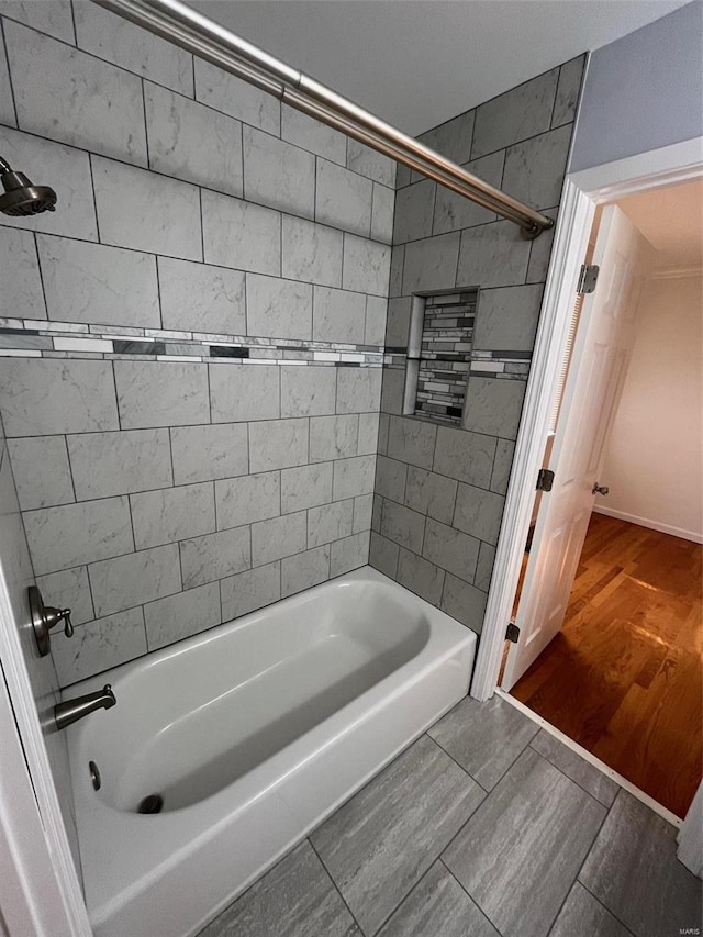 bathroom with tiled shower / bath and hardwood / wood-style floors