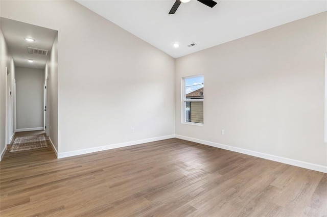 empty room with ceiling fan and light hardwood / wood-style flooring