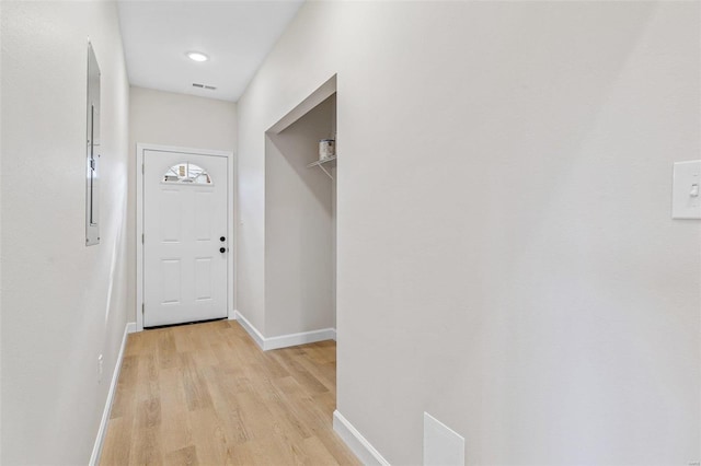 hallway with light hardwood / wood-style floors