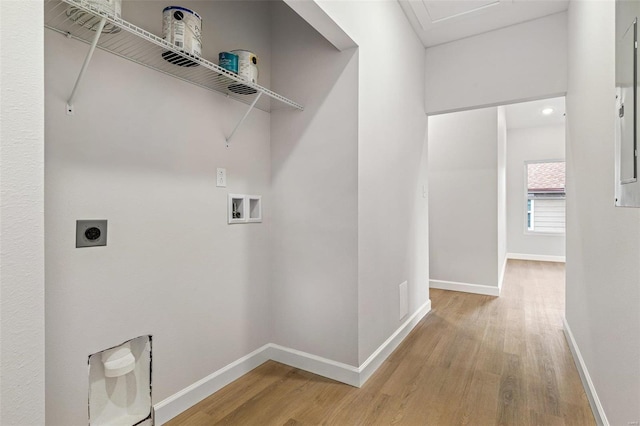 clothes washing area with light wood-type flooring, washer hookup, and hookup for an electric dryer