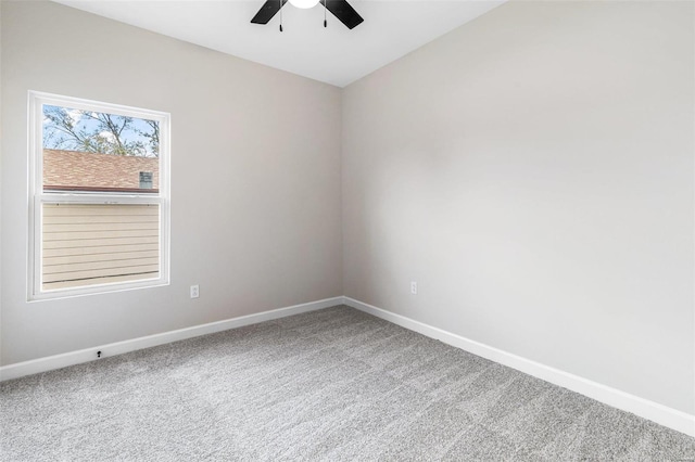 carpeted spare room featuring ceiling fan