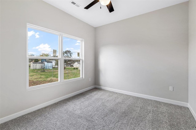 spare room featuring ceiling fan and carpet floors