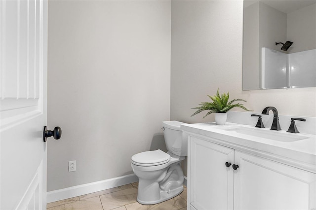 bathroom featuring toilet, a shower, vanity, and tile patterned flooring