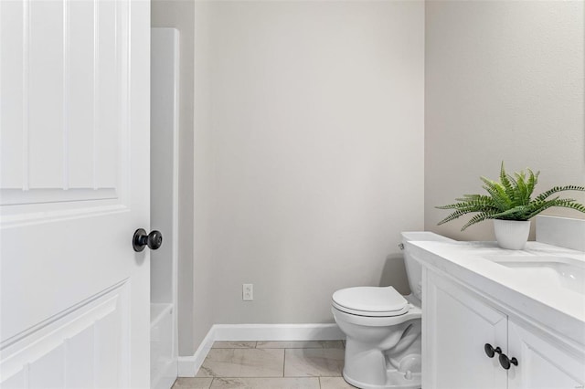 bathroom with vanity, toilet, and a bath