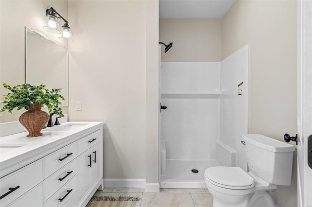 bathroom with walk in shower, tile patterned floors, vanity, and toilet