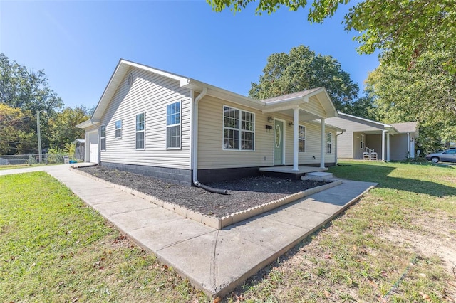 view of front of home featuring a garage, covered porch, and a front lawn