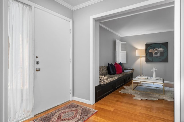 foyer with wood-type flooring and crown molding