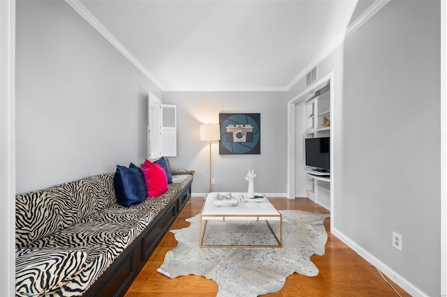 living room featuring hardwood / wood-style flooring and crown molding