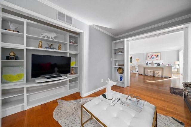 living room with wood-type flooring and ornamental molding