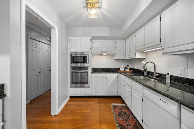 kitchen featuring stainless steel appliances, sink, and white cabinetry