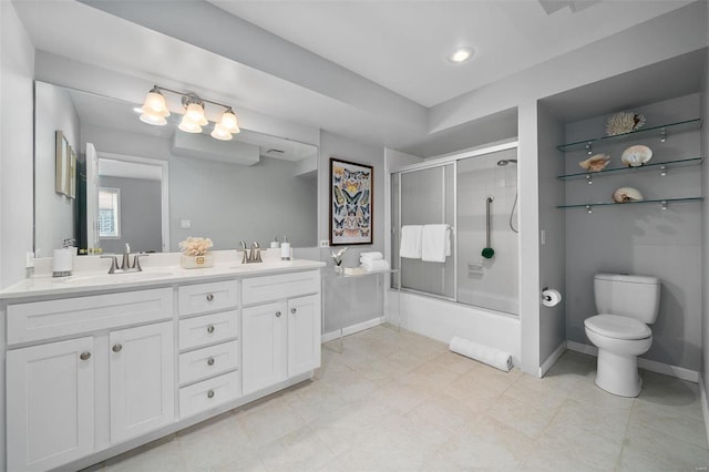 full bathroom with bath / shower combo with glass door, vanity, and toilet