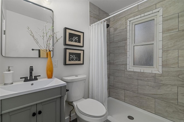 bathroom with vanity, toilet, and a shower with curtain