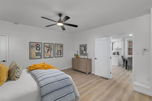 bedroom with ceiling fan and light hardwood / wood-style floors