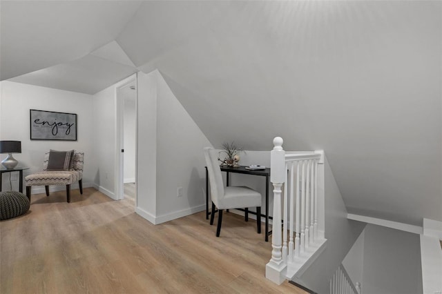 interior space with vaulted ceiling and light hardwood / wood-style flooring