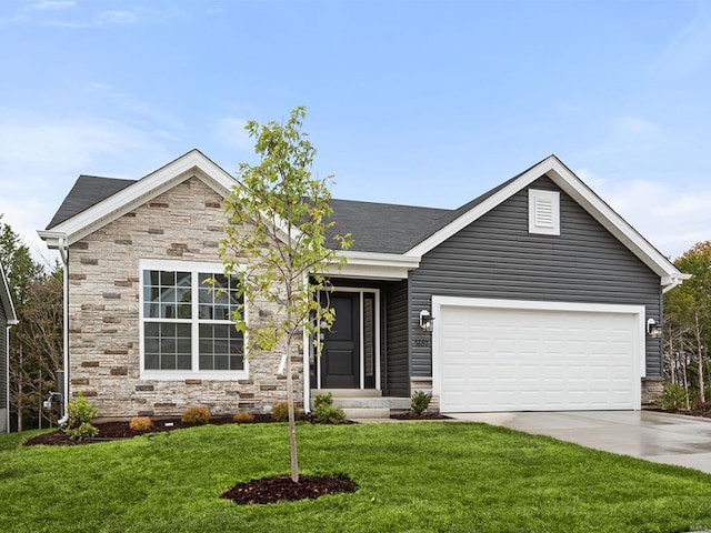 view of front of property featuring a front yard and a garage