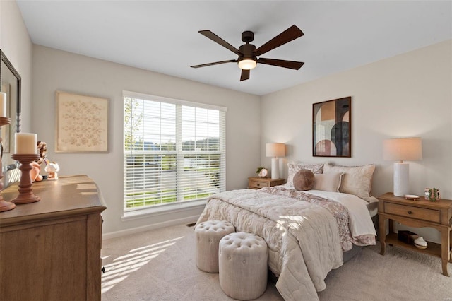 bedroom featuring light colored carpet and ceiling fan