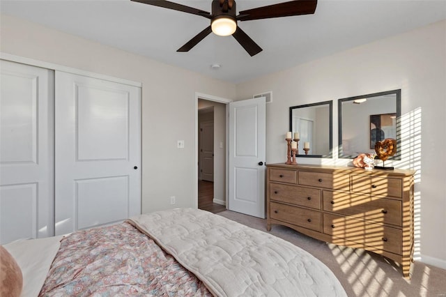 bedroom with a closet, carpet, and ceiling fan