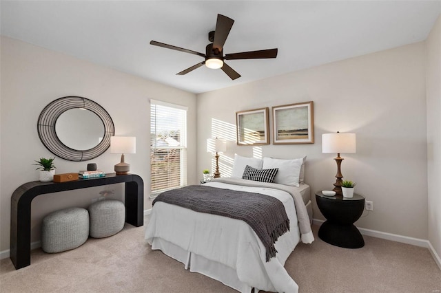 bedroom featuring light colored carpet and ceiling fan