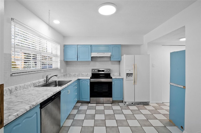 kitchen with blue cabinetry, stainless steel appliances, and sink