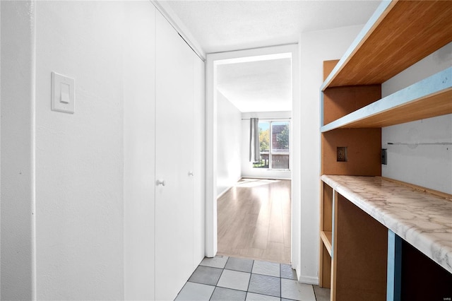 hallway featuring light tile patterned flooring