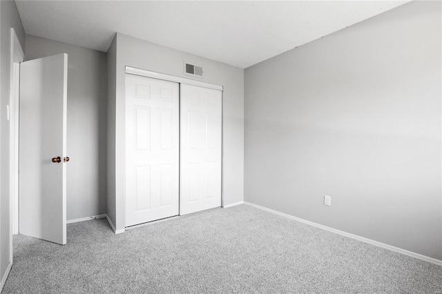 unfurnished bedroom featuring a closet and carpet floors