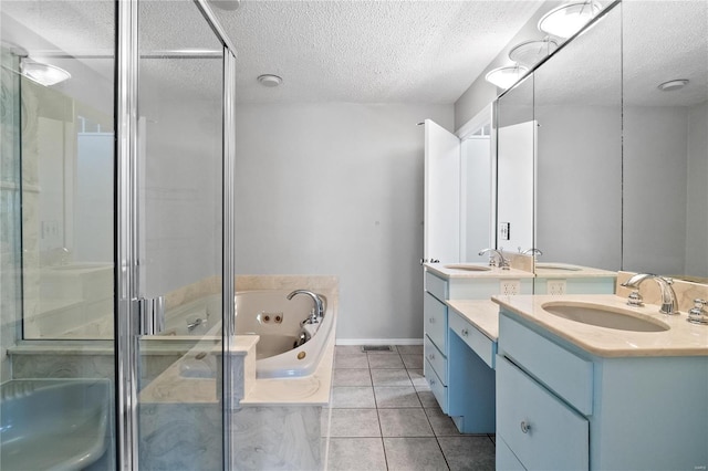 bathroom featuring vanity, a textured ceiling, tile patterned floors, and independent shower and bath